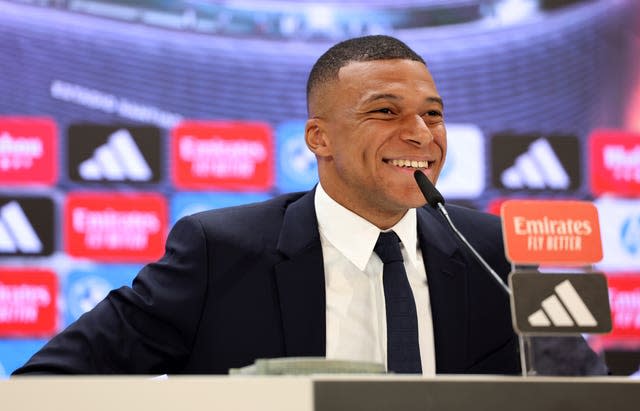 Kylian Mbappe smiles during a press conference