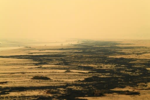 Ash from Australia's bushfires washes up on a beach in Merimbula, New South Wales state