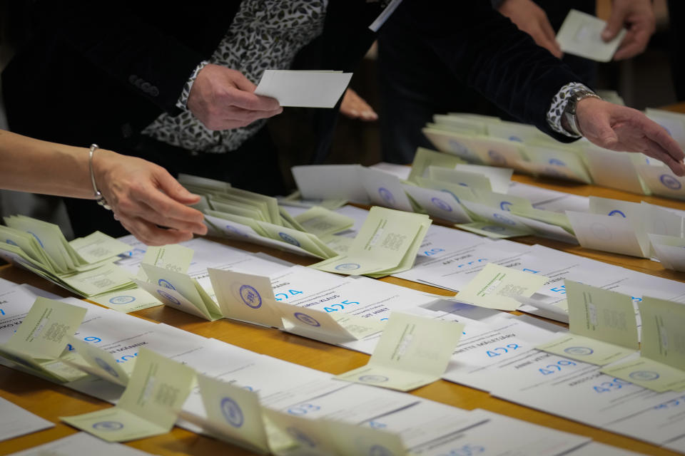 Electoral commission staff count ballot papers after voting closed at a polling station in Tallinn, Estonia, Sunday, March 5, 2023. Voters in Estonia cast ballots Sunday in a parliamentary election that the center-right Reform Party of Prime Minister Kaja Kallas, one of Europe's most outspoken supporters of Ukraine, was considered a favorite to win. (AP Photo/Sergei Grits)