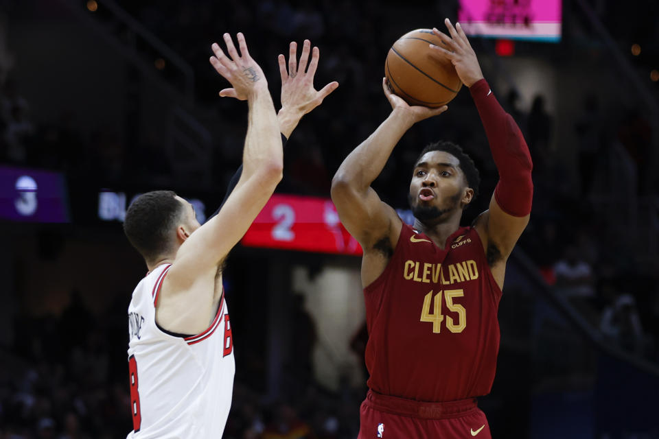 Cleveland Cavaliers guard Donovan Mitchell (45) shoots against Chicago Bulls guard Zach LaVine (8) during the second half of an NBA basketball game, Monday, Jan. 2, 2023, in Cleveland. (AP Photo/Ron Schwane)