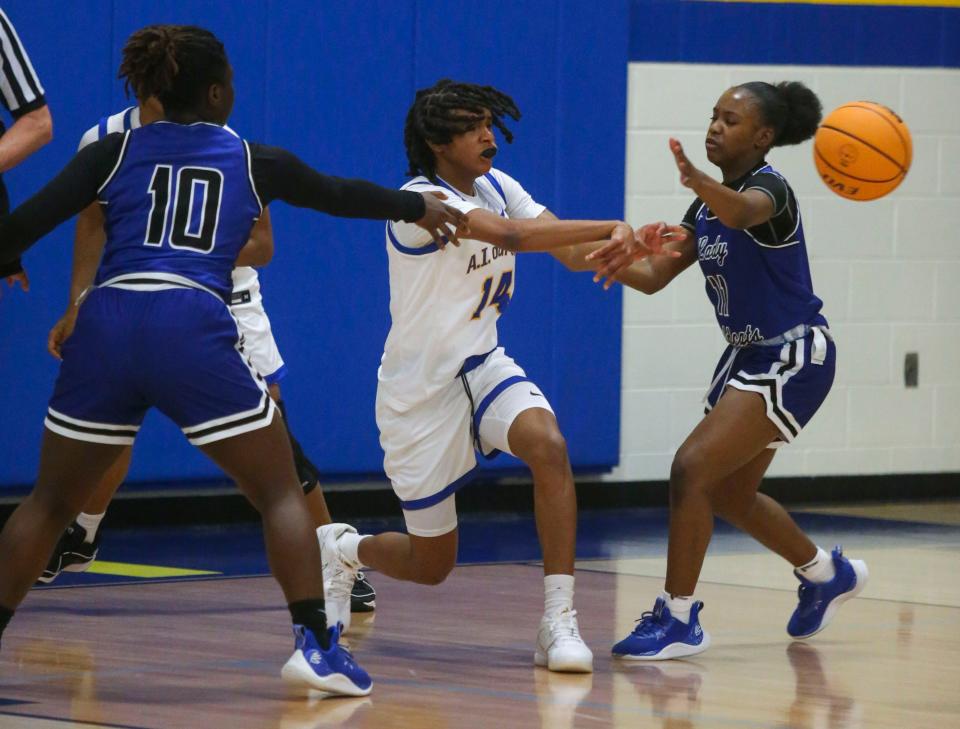 Howard's Glory Forbi-Mbunwe (10) and Aaliyah Johnson defend against A.I. du Pont's Sydney Hilliard in the Tigers' 64-54 win at A.I. du Pont on Jan. 26.
