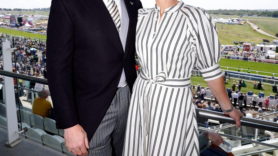 zara tindall in a striped dress with a bleted waistline