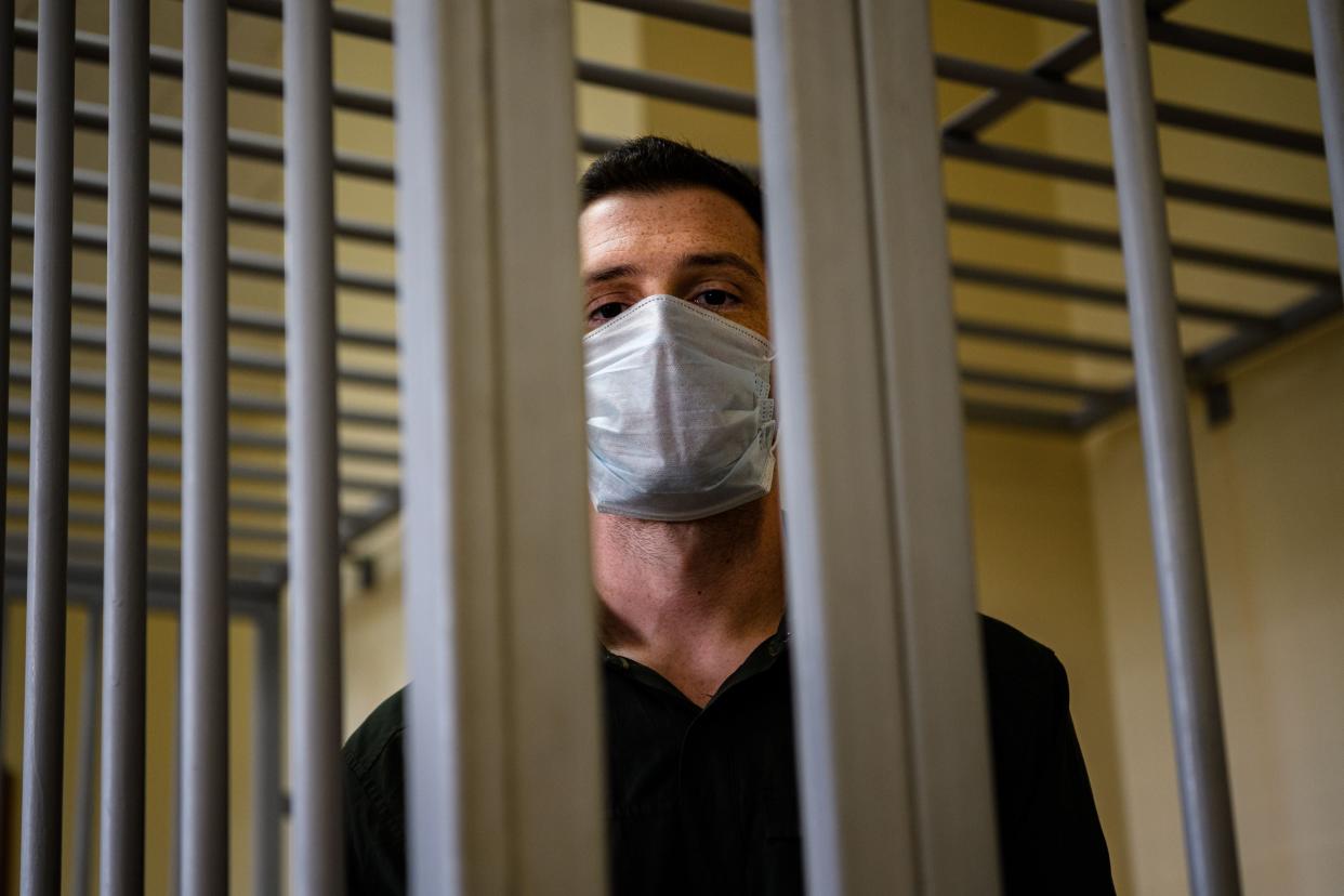 US ex-marine Trevor Reed, then charged with attacking police, stands inside a defendants’ cage during his verdict hearing at Moscow’s Golovinsky district court on 30 July, 2020.  (AFP via Getty Images)