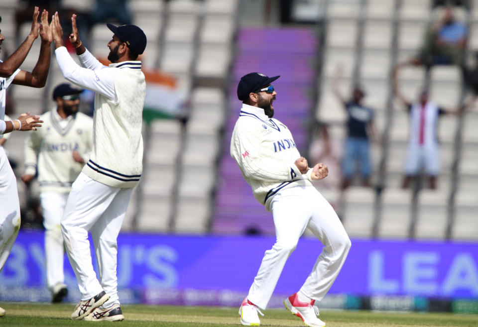 India's captain Virat Kohli, right, and teammates celebrate the dismissal of New Zealand's Tom Latham during the sixth day of the World Test Championship final cricket match between New Zealand and India, at the Rose Bowl in Southampton, England, Wednesday, June 23, 2021. (AP Photo/Ian Walton)