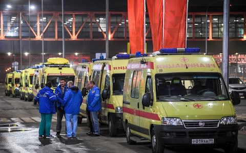 Ambulances are parked in front of the terminal building of the Sheremetyevo Airport outside Moscow - Credit: AFP