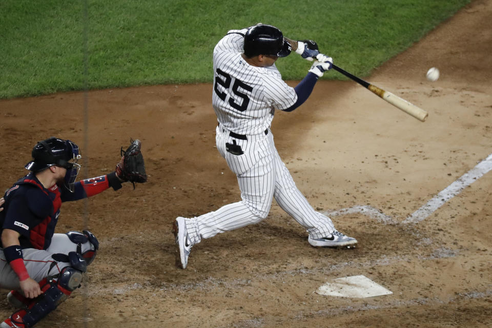 New York Yankees' Gleyber Torres (25) hits a solo home run during the fifth inning in the second baseball game of the team's doubleheader against the Boston Red Sox, Saturday, Aug. 3, 2019, in New York. Red Sox catcher Christian Vazquez is behind the plate. (AP Photo/Kathy Willens)