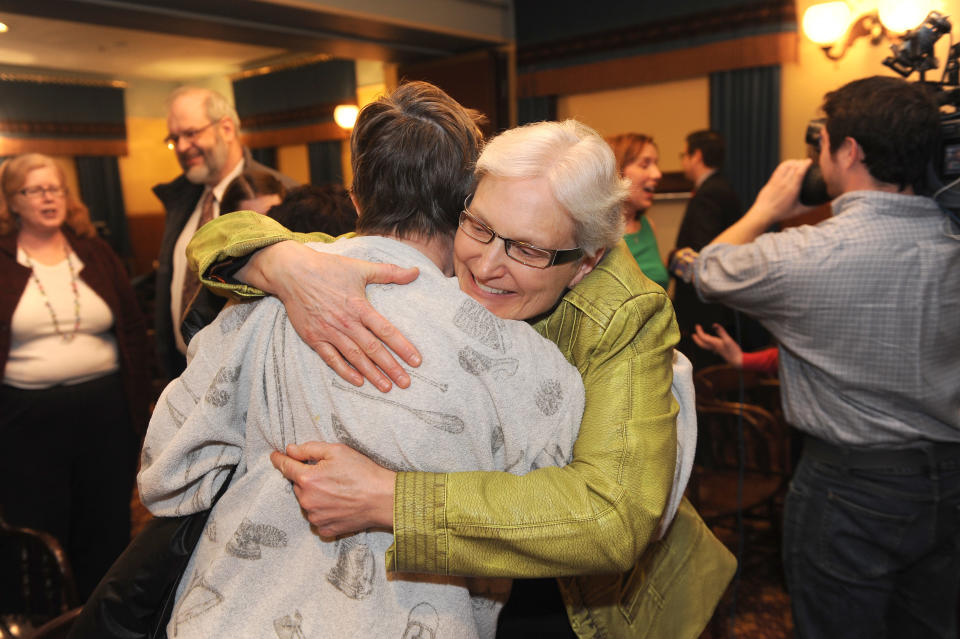 Marsha Caspar, right, hugs Elaine Thomason during a news conference in Lansing, Mich., Tuesday, March 25, 2014. They hope their marriages to their partners will stay legal and were on hand as the 14,756 signatures on a petition for Governor Rick Snyder and Attorney General Bill Schuette to drop their appeal on same sex marriage were delivered. (AP Photo/The Detroit News, Max Ortiz)