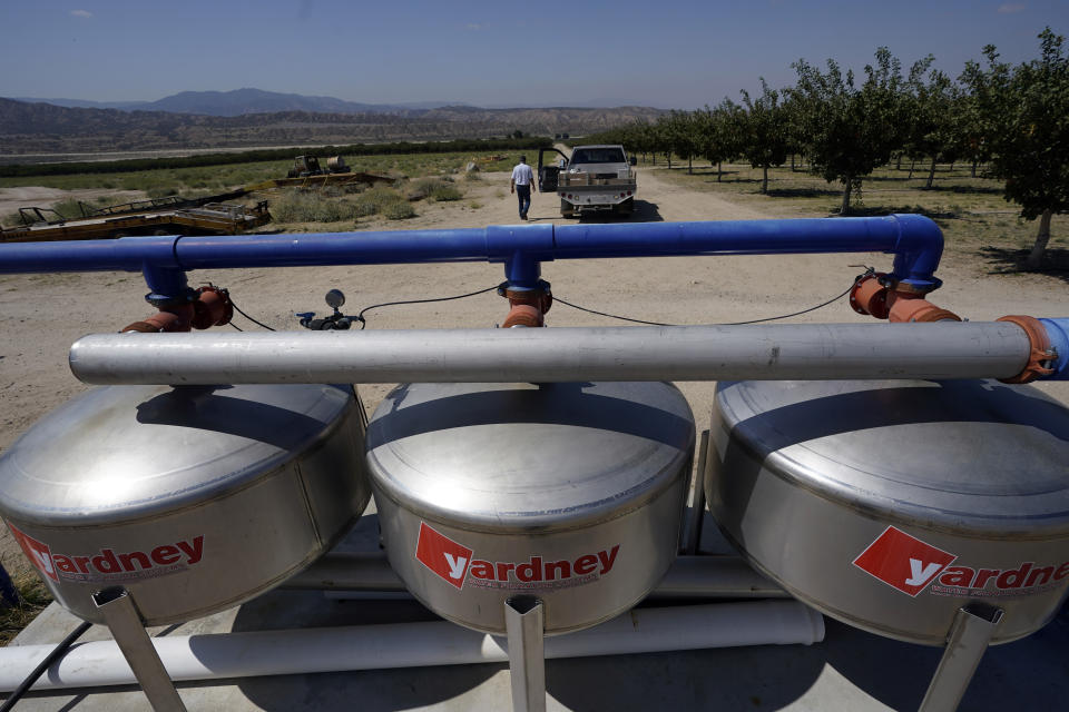 A water filtration system is placed next to a pistachio orchard owned by Jim Harrington, Wednesday, Sept. 20, 2023, in Ventucopa, Calif. Harrington is one of the small farmers, cattle ranchers and others living near the tiny town of New Cuyama whose water supplies and livelihoods are at the heart of a groundwater rights lawsuit brought by two of the nation's biggest carrot farming companies. (AP Photo/Marcio Jose Sanchez)