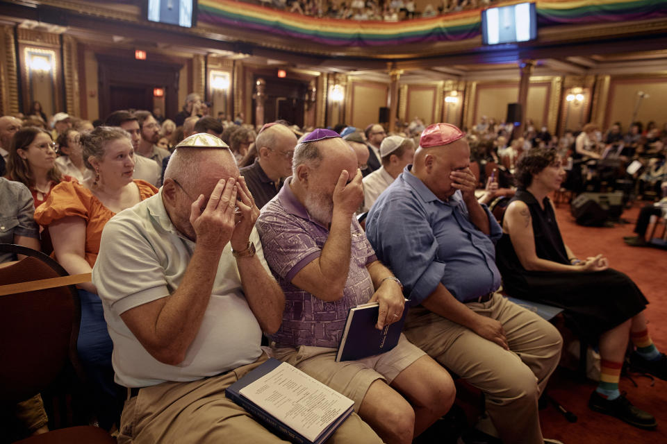 Worshippers pray with Rabbi Sharon Kleinbaum as she speaks during her last service at the Masonic Hall, Friday, June 28, 2024, in New York. (AP Photo/Andres Kudacki)