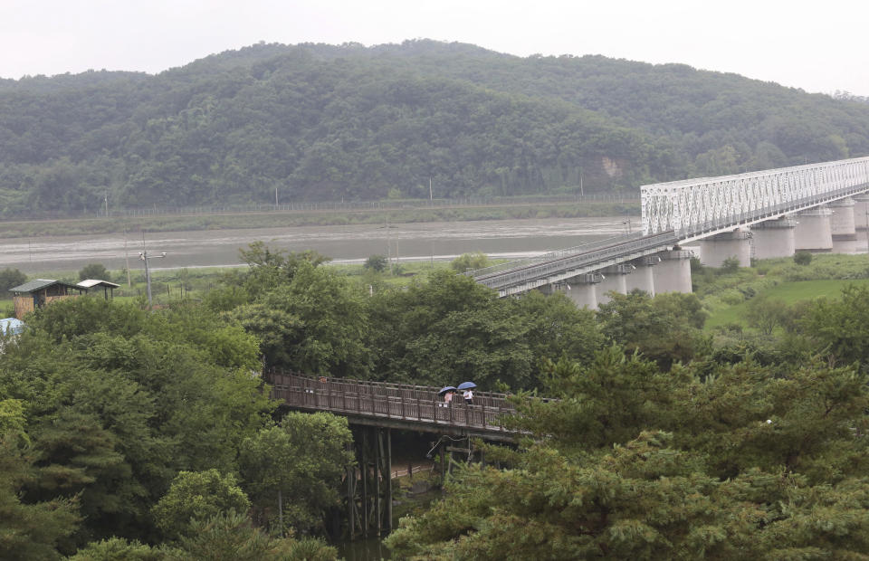 Visitors walk on the Freedom Bridge at the Imjingak Pavilion in Paju, near the border with North Korea, South Korea, Wednesday, July 31, 2019. South Korea's military said North Korea conducted its second weapons test in less than a week Wednesday, firing two short-range ballistic missiles off its east coast in a move observers say could be aimed at boosting pressure on the United States as the rivals struggle to set up fresh nuclear talks.(AP Photo/Ahn Young-joon)