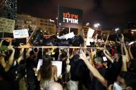 Israelis carry a stretcher as they protest against the government's response to the financial fallout of the coronavirus disease (COVID- 19) crisis at Rabin square in Tel Aviv