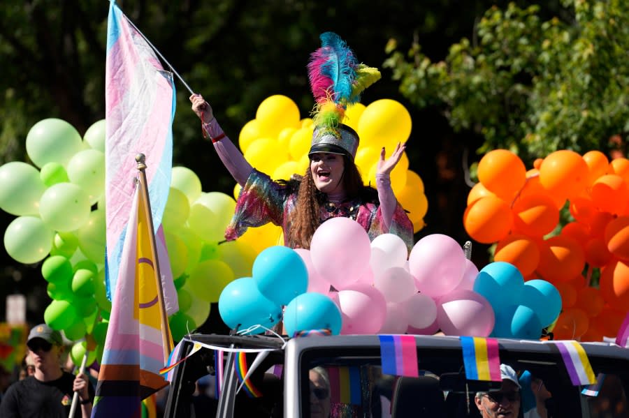 Entertainer Ophelia Peaches waves while riding on a float in the Pride parade through the streets of downtown Denver, Sunday, June 25, 2023. (AP Photo/David Zalubowski)