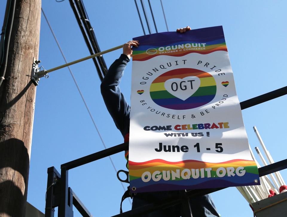 A flag advertising the town's upcoming Pride events.