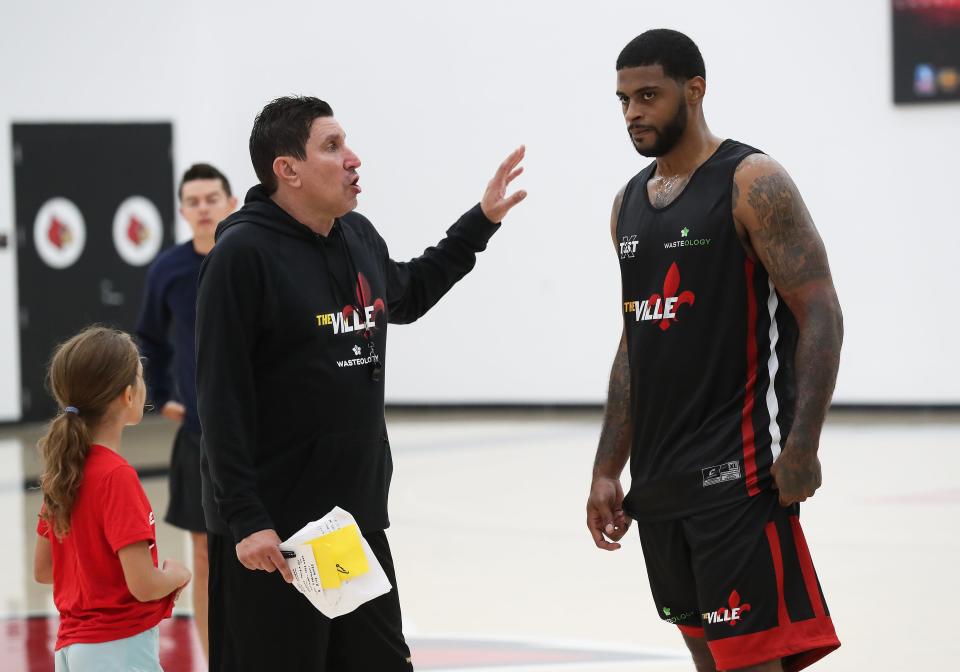The Ville head coach Mark Lieberman, left, instructs former U of L basketball player Chane Behanan during a practice at the Kueber Center in Louisville, Ky. on July 18, 2023.