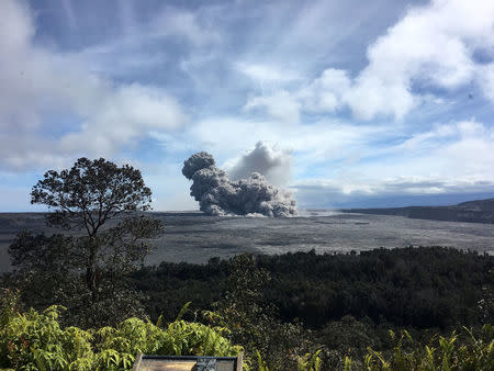 A rising ash plume from Halema'uma'u, a crater at the summit of Kilauea, is seen from the caldera rim near Volcano House in Hawaii, U.S. May 24, 2018. Picture taken May 24, 2018. USGS/Handout via REUTERS