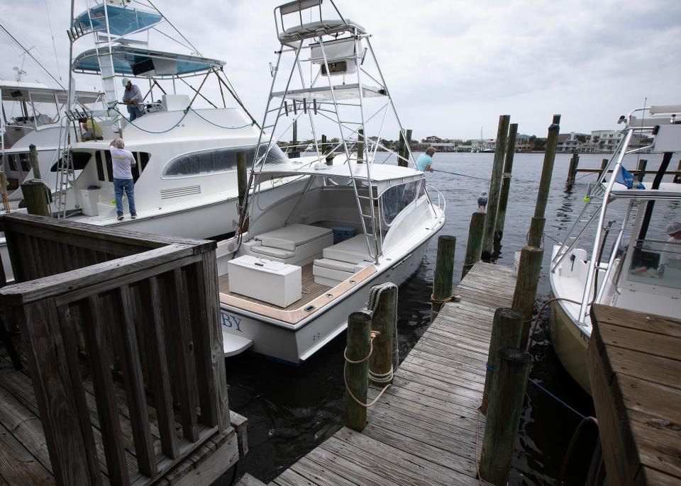The 30-foot 1974 G&S boat "Hey Baby," center, is seen moored at the Harbor Docks' marina and seafood restaurant in Destin, Fla., April 1, 2024.