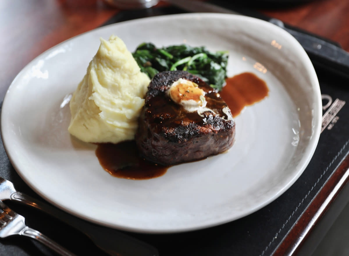 mccormick&shmicks' steak, mashed potatoes, and spinach on white plate