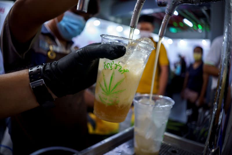 Bartenders serve cannabis-mixed sparkling craft soda during the "360 Cannabis & Hemp for the People" expo in Buriram province