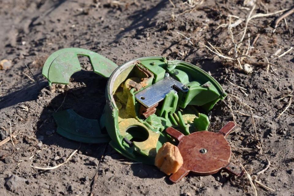 Parts of a defused Russian antipersonnel mine seen on a farm field during a demining operation in Velyka Oleksandrivka, Ukraine on Oct. 12, 2023. (Andriy Andriyenko/SOPA Images/LightRocket via Getty Images)