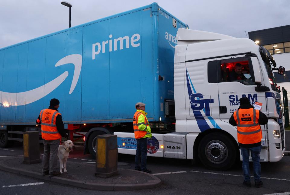 Amazon workers from the GMB union, talk to a lorry driver passing a picket line outside the Amazon fulfilment centre in Coventry, central England