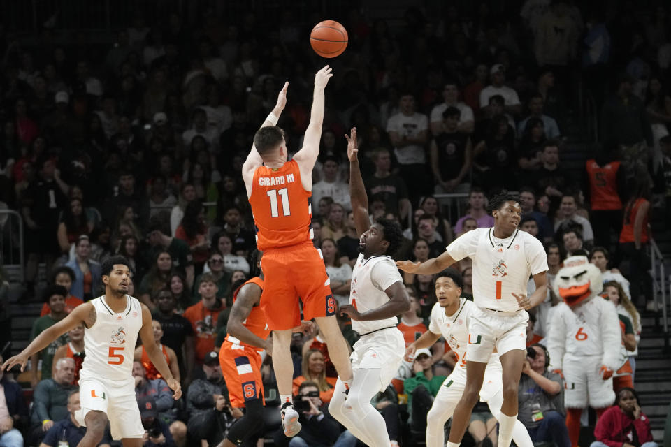 Syracuse guard Joseph Girard III (11) shoots over Miami guard Bensley Joseph during the first half of an NCAA college basketball game, Monday, Jan. 16, 2023, in Coral Gables, Fla. (AP Photo/Lynne Sladky)