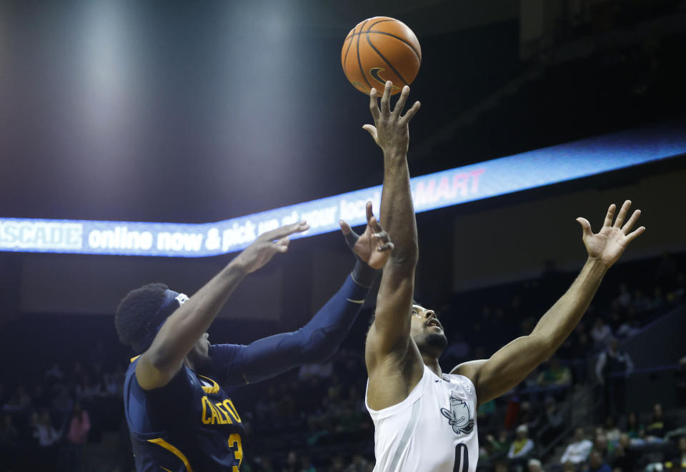 Oregon guard Kario Oquendo (0), goes for a rebound against California guard Keonte Kennedy (3), during the second half of an NCAA college basketball game in Eugene, Ore., Saturday, Jan. 13, 2024. (AP Photo/Thomas Boyd)