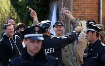 German neo-Nazi Thomas Wulff (centre) is surrounded by police as he protests outside the courthouse in Lueneburg, northern Germany, on April 21, 2015