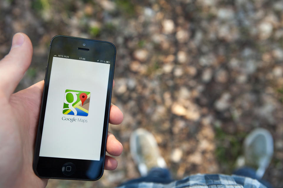 Nizhnevartovsk, Russia - June 12, 2013: Man hand holding iPhone 5 with Google Maps App on outdoors. iPhone is product Apple Inc. Google Maps is a web mapping service application and technology provided by Google.