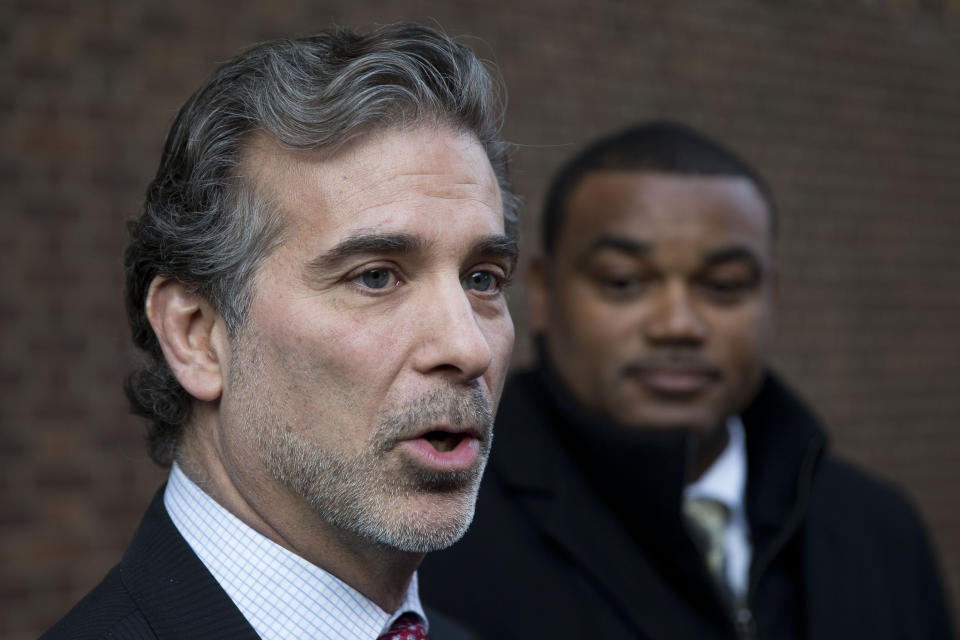 FILE - Co-lead players' lawyer Christopher Seeger, left, speaks with members of the media after a hearing on the proposed NFL concussion settlement outside of the U.S. Courthouse on Nov. 19, 2014, in Philadelphia. Hundreds of Black NFL retirees denied payouts in the $1 billion concussion settlement now qualify for awards after their tests were rescored to eliminate racial bias. Changes to the settlement made last year are meant to make the tests race-blind. (AP Photo/Matt Rourke, File)