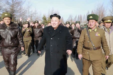 North Korean leader Kim Jong Un walks as he inspects the KPA Air and Anti-Air Force Unit 991, honoured with the title of O Jung Hup-led Seventh Regiment, in this undated photo released by North Korea's Korean Central News Agency (KCNA) in Pyongyang November 21, 2014. REUTERS/KCNA