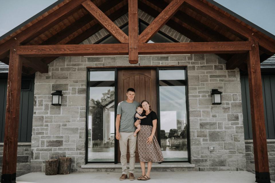 The Bultje family standing outside their sustainable home in Ontario, Canada.