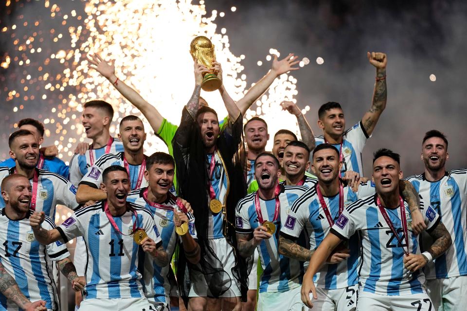 Argentina's Lionel Messi lifts the trophy after winning the World Cup final soccer match between Argentina and France at the Lusail Stadium in Lusail, Qatar, Sunday, Dec. 18, 2022. Argentina won 4-2 in a penalty shootout after the match ended tied 3-3. (AP Photo/Martin Meissner)