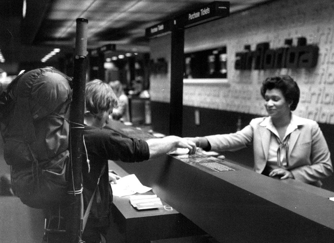 An Air Florida ticket agent helps travelers in 1984.