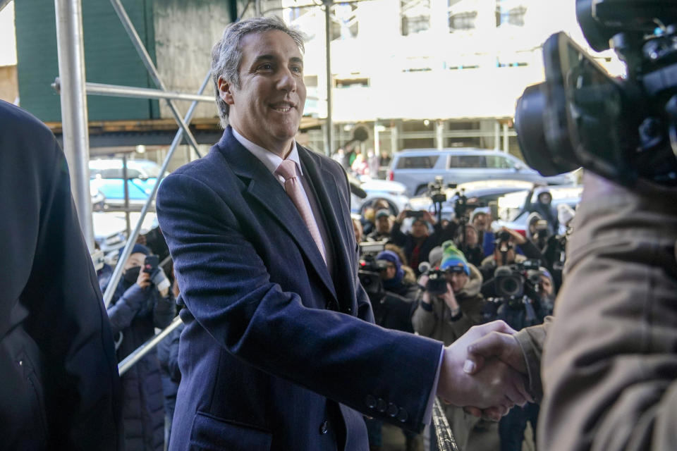 Donald Trump’s former lawyer and fixer Michael Cohen greets a photojournalist as he arrives for a second day of testimony before a grand jury investigating hush money payments he arranged and made on the former president’s behalf, Wednesday, March 15, 2023, in New York. (AP Photo/Mary Altaffer)