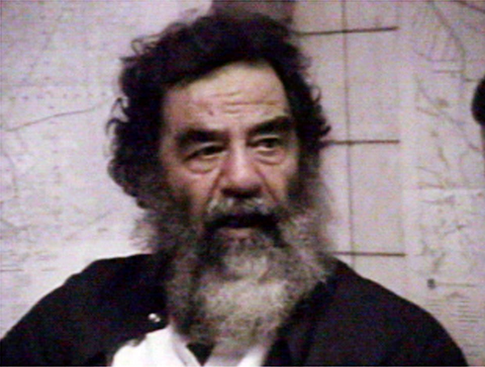 Saddam Hussein is filmed after his capture in this file footage released December 14, 2003. Iraqi Interim President Ghazi al-Yawar, said June 15, 2004 that toppled Iraqi president Saddam Hussein would be handed over to the new government once procedures were in place to protect his life and give him a fair trial. 