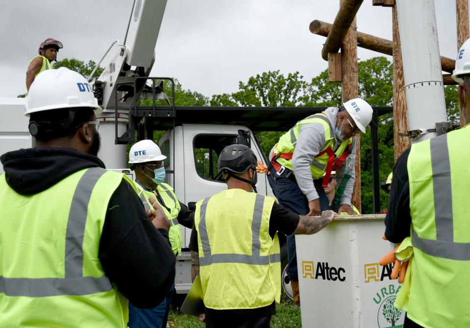 Gerald Nelson, 58, of Southfield, getting into the bucket of the Urban Tree Trimming truck to move up 80 feet in the truck to shoot the ball into the basket as part of the training exercise at the Tree Trim Academy in Detroit DTE on Tuesday, June 7, 2022.