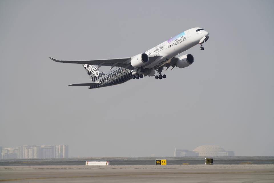 An Airbus A350 takes off at the Dubai Air Show in Dubai, United Arab Emirates, Wednesday, Nov. 17, 2021. (AP Photo/Jon Gambrell)