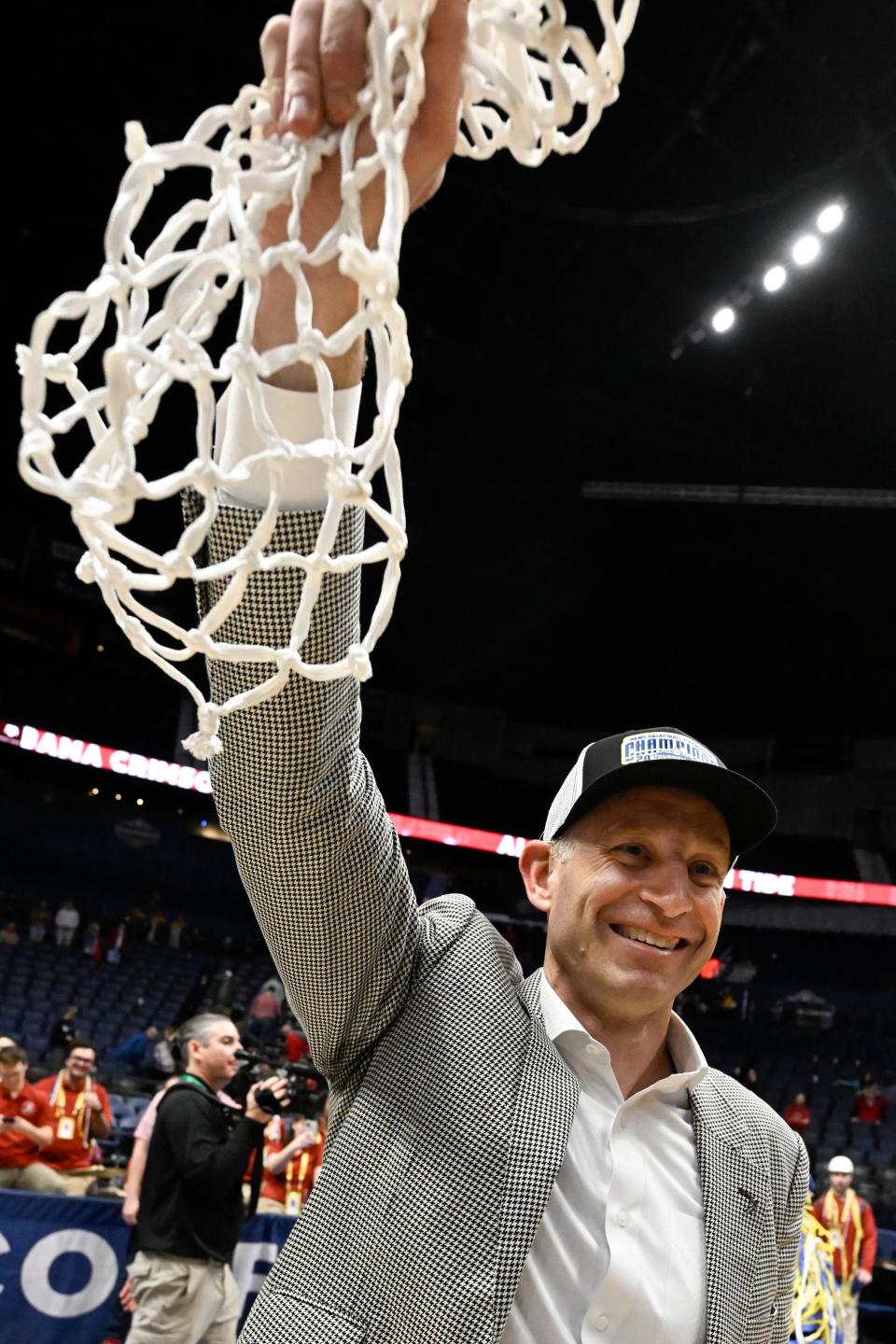 Alabama head coach Nate Oats holds up the net after an NCAA college basketball game against Texas A&M in the finals of the Southeastern Conference Tournament, Sunday, March 12, 2023, in Nashville, Tenn. Alabama won 82-63. (AP Photo/John Amis)