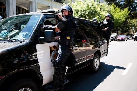 Sacramento Police officers follow counter-protestors after multiple people were stabbed during a clash between neo-Nazis holding a permitted rally and counter-protestors on Sunday at the state capitol in Sacramento, California, United States, June 26, 2016. REUTERS/Max Whittaker