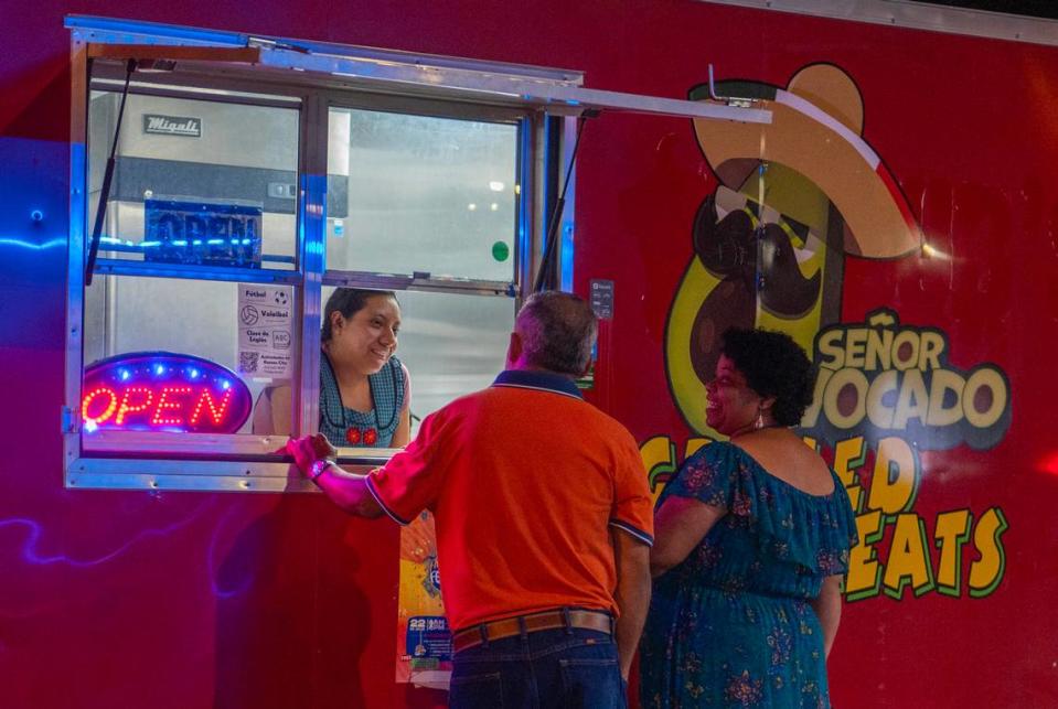 Celia Altamirano, left, takes an order from inside the Señor Avocado food truck.