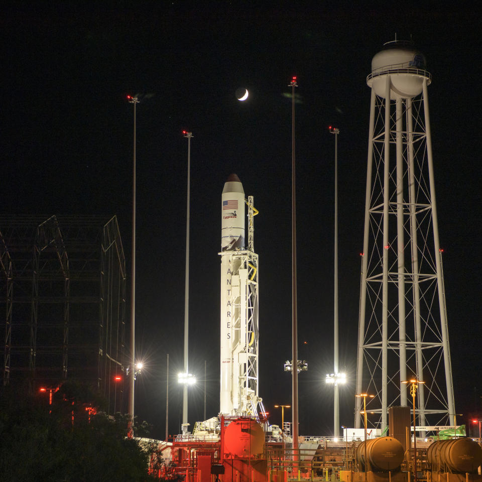 The crescent Moon is seen above the Northrop Grumman Antares rocket at launch Pad-0A, Friday, Nov. 1, 2019, at NASA's Wallops Flight Facility in Wallops Island, Va. Northrop Grumman's 12th contracted cargo resupply mission with NASA to the International Space Station will deliver about 8,200 pounds of science and research, crew supplies and vehicle hardware to the orbital laboratory and its crew. Launch is scheduled for 9:59 a.m. EDT Saturday, Nov. 2. (Bill Ingalls/NASA via AP)