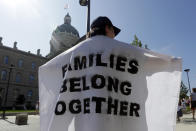 <p>Katy Heath holds a flag during a protest of the Trump administration’s approach to illegal border crossings and separation of children from immigrant parents at the Statehouse, Saturday, June 30, 2018, in Indianapolis, Ind. (Photo: Darron Cummings/AP) </p>