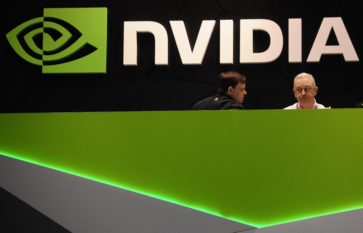FILE - People gather in the Nvidia booth at the Mobile World Congress mobile phone trade show Thursday, Feb. 27, 2014 in Barcelona, Spain.  The Securities and Exchange Commission says it's settled charges against Nvidia, Friday, May 6, 2022, for “inadequate disclosures