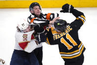 Boston Bruins center Trent Frederic (11) fights Florida Panthers left wing Ryan Lomberg (94) during the final seconds in Game 2 in the first-round series of the NHL hockey playoffs Wednesday, April 19, 2023, in Boston. The Panthers defeated the Bruins 6-3. (AP Photo/Charles Krupa)