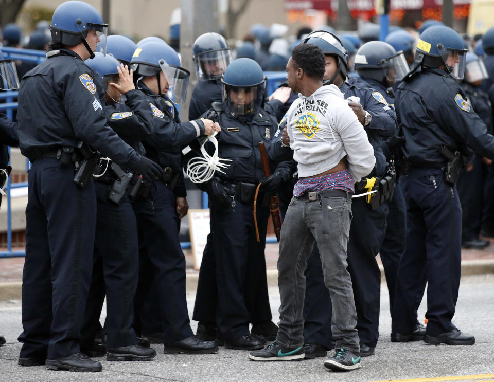 Police detain a man after a march to City Hall for Freddie Gray, Saturday, April 25, 2015 in Baltimore. Gray died from spinal injuries about a week after he was arrested and transported in a police van. (AP Photo/Alex Brandon)