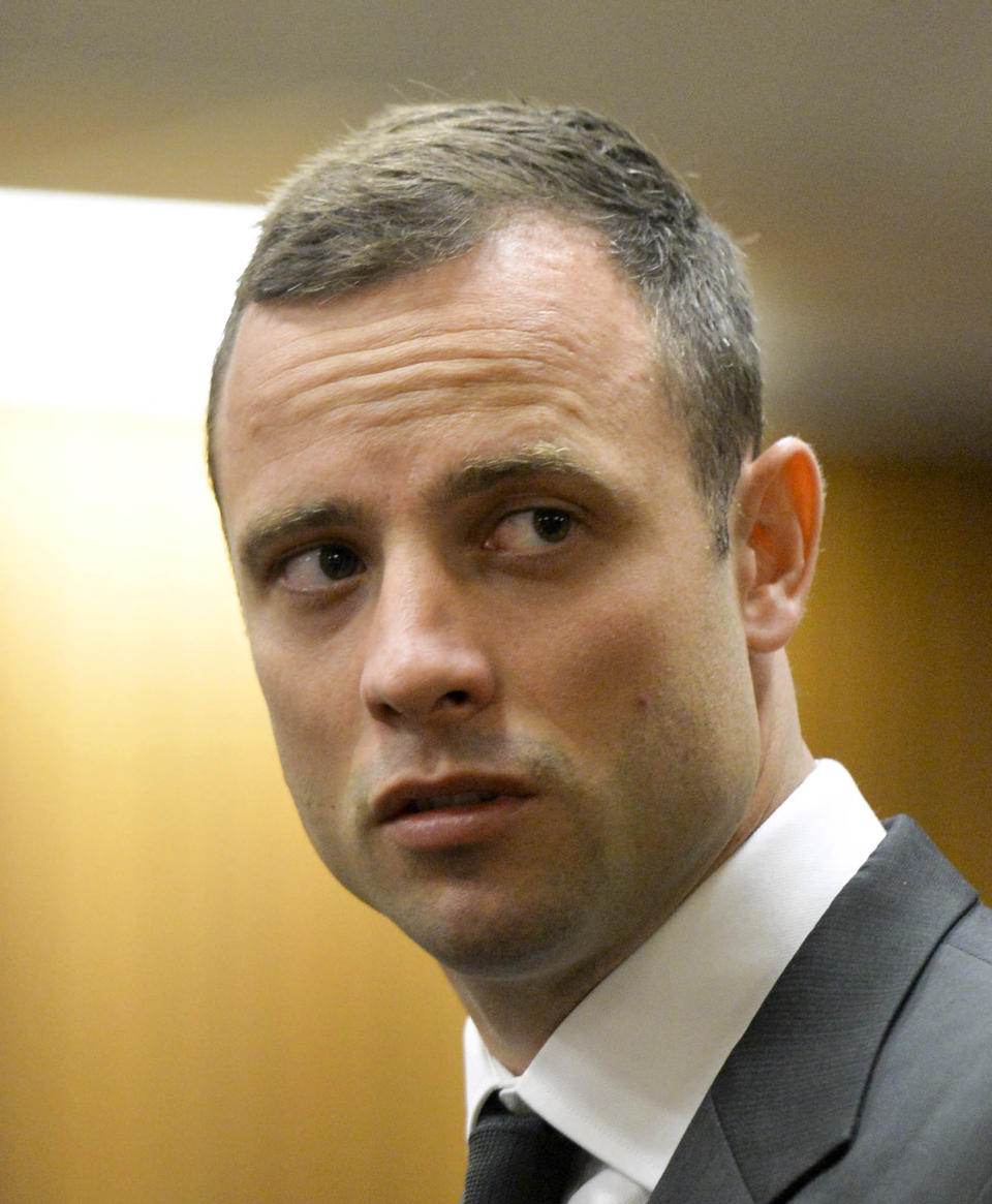 Oscar Pistorius waits for the start of his trial at the high court in Pretoria, South Africa, Monday, March 3, 2014. Pistorius is charged with murder with premeditation in the shooting death of girlfriend Reeva Steenkamp in the pre-dawn hours of Valentine's Day 2013. (AP Photo/Herman Verwey, Pool)