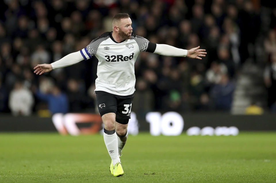 Derby County's Wayne Rooney gestures to his team-mates during the match against Barnsley, during their English Championship soccer match at Pride Park in Derby, England, Thursday Jan. 2, 2020. (Bradley Collyer/PA via AP)