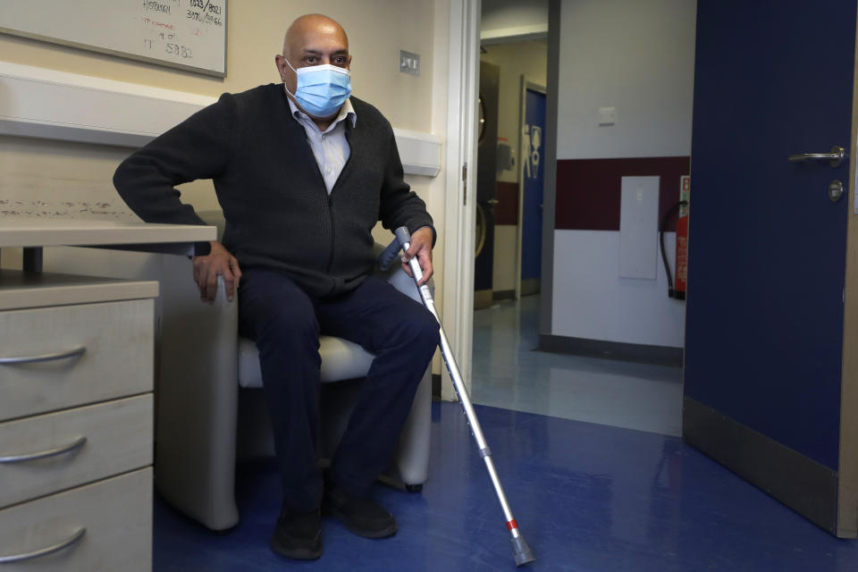 Long COVID patient Rohit Patel takes a seat during a visit to the Long COVID Clinic at King George Hospital in Ilford, London, Tuesday, May 11, 2021. At King George Hospital, a clinic has been set up to help patients suffering months after they were infected with COVID-19. It's one of 83 "long COVID" clinics in England where medics and patients are grappling with the enduring effects of the virus. (AP Photo/Kirsty Wigglesworth)