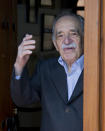 In this March 6, 2014, photo, Colombian Nobel Literature laureate Gabriel Garcia Marquez greets fans and reporters outside his home on his 87th birthday in Mexico City. Garcia Marquez died Thursday April 17, 2014 at his home in Mexico City. The author's magical realist novels and short stories exposed tens of millions of readers to Latin America's passion, superstition, violence and inequality. (AP Photo/Eduardo Verdugo)