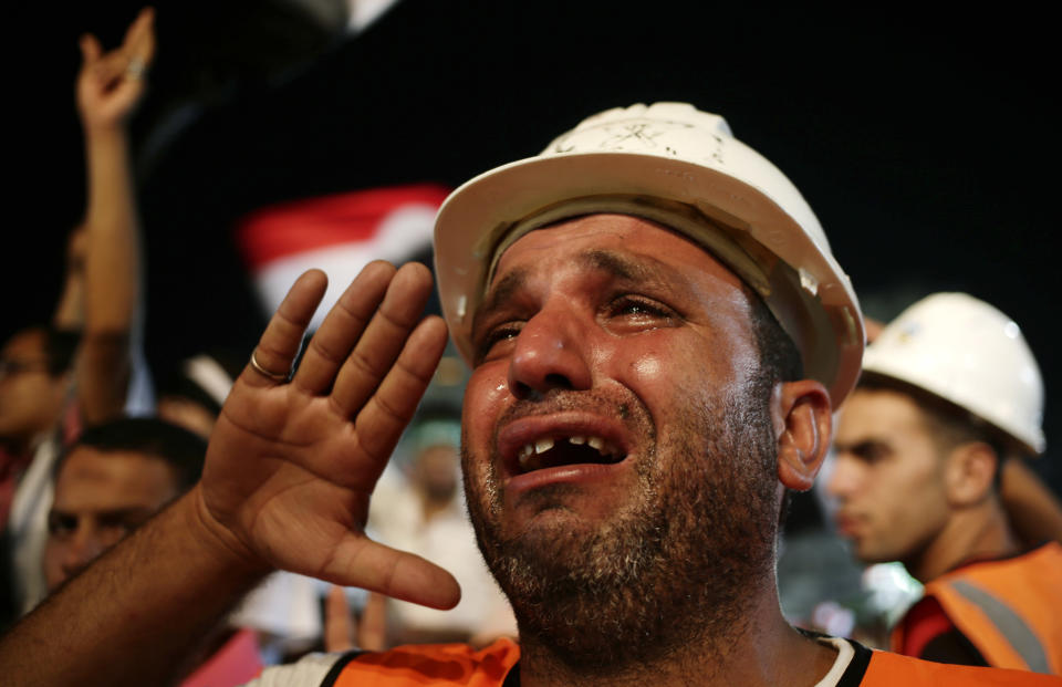 A supporter of Egypt's ousted President Mohammed Morsi cries while saluting the Egyptian flag at Rabaah al-Adawiya mosque, where supporters of Egypt's ousted President Mohammed Morsi have installed a camp and hold daily rallies at Nasr City, in Cairo, Egypt, Thursday, Aug. 1, 2013. (AP Photo/Hassan Ammar)